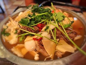 Beef and Vegetable Soup with Cilantro in Metal Pot